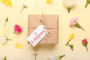 Beautiful greeting card for International Women's Day with gift and fresh flowers