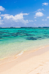 Tropical white sandy beach, perfect clear blue turquoise water and clear blue sky on a paradise island in the Pacific Ocean in Muri area of Rarotonga, Cook Islands, background with copy space