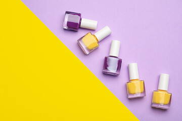 Set of nail polish bottles on color background