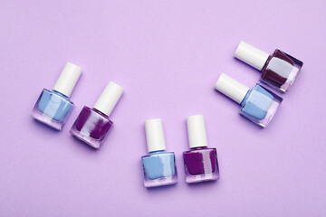Set of nail polish bottles on color background
