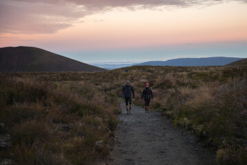 Obraz premium Hikers starting the Tongariro Alpine Crossing Trek at sunrise, Tongariro National Park, North Island, New Zealand