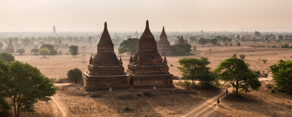 Tourists exploring the Temples of Bagan (Pagan) at sunrise, Myanmar (Burma)