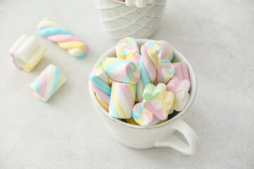 Cup with sweet marshmallows on white background