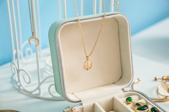 Opened jewelry box with stylish necklace, closeup