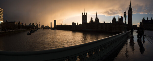Houses of Parliament (Palace of Westminster) and Big Ben silhouetted at sunset, seen from...