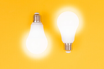 A Power Saving Lamps on Yellow Background - Top View