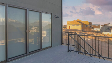 Panorama Puffy clouds at sunset Deck of a house with sliding glass door and wooden planks floori