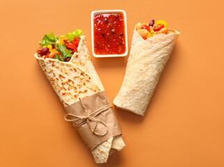 Delicious burritos and sauce on color background - obrazy, fototapety, plakaty