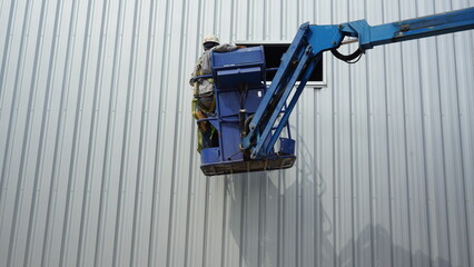 Workers are installing galvanized sheets.