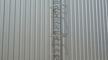 Fire escape stairs are mounted on galvanized sheet.