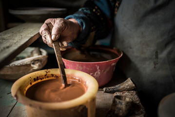 Woman making Horezu ceramics, a unique type of Romanian pottery, UNESCO Cultural Heritage List,...