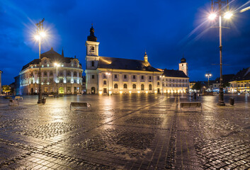 Obraz na płótnie Canvas Sibiu City Hall and Baroque Jesuit Church in Piata Mare (Great Square) at night, Transylvania, Romania