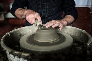 Throwing a pot on a pottery wheel at a Marginea Black Pottery and Ceramics workshop, Bukovina, Romania