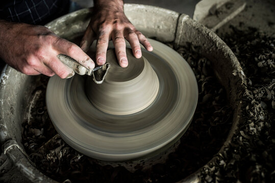 Throwing a pot on a pottery wheel at a Marginea Black Pottery and Ceramics workshop, Bukovina, Romania