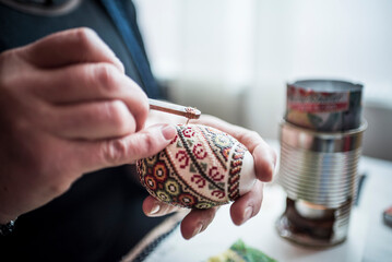 Lady making traditional decorated eggs in the Bukovina Region of Romania