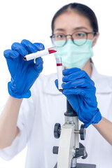 Asian researcher woman with face mask and glasses holding medical tube