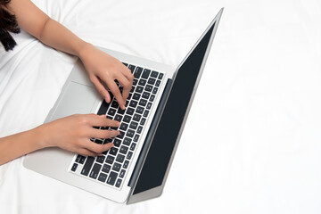 Woman lying down while using laptop