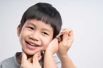 Asian mother cleaning her 4 years old boy ear with cotton swab