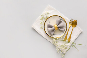Stylish table setting with flowers on light background