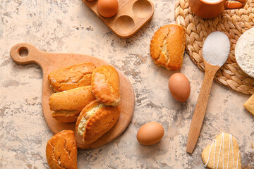 Wooden board of tasty sochniki with cottage cheese and eggs on beige background