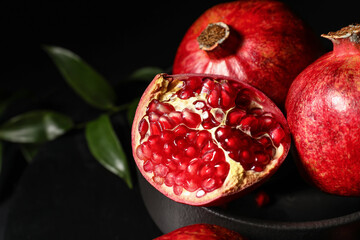 Ripe delicious pomegranate on dark background