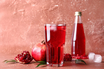 Glass of iced pomegranate juice on red background
