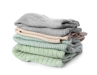 Stack of folded sweaters on white background