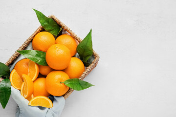 Box with fresh juicy oranges on white background