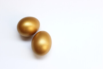 The golden eggs isolated on the white background