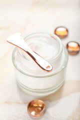 Jar with natural cosmetic cream on light background, closeup
