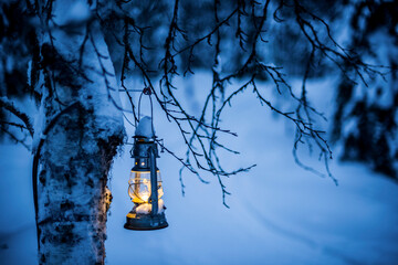 Christmas glass lantern in a mysterious winter forest scenery, Lapland, Arctic Circle, Finland