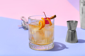 Glass of delicious Old Fashioned Cocktail on color background