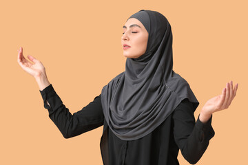 Muslim woman praying on color background