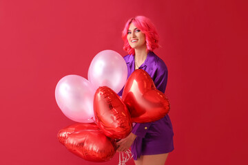 Stylish woman with bright hair and air balloons on color background. Valentine's Day celebration