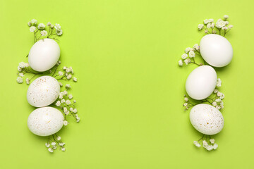 Composition with beautiful Easter eggs and gypsophila flowers on green background