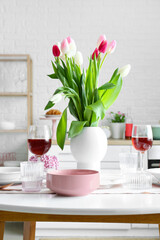 Dining table with stylish setting for International Women's Day celebration