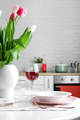 Dining table with setting for International Women's Day celebration in kitchen
