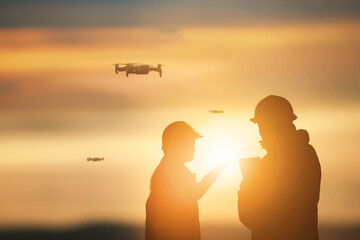 Silhouette of Engineers checking project at wind farm site on sunset. - 485727221