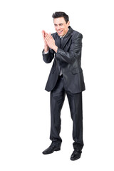 Cunning businessman rubbing hands in studio. White background.