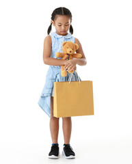 Portrait full body studio cutout shot Asian young pigtail braid hair shopper girl in blue dress standing smiling holding brown bear doll and paper shopping bag look at camera on white background