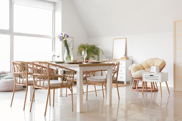 Interior of light room with dining table served for International Women's Day celebration