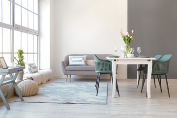 Interior of stylish room with table served for International Women's Day celebration