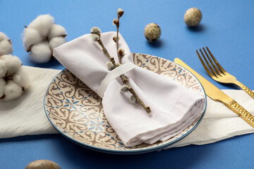 Beautiful table setting for Easter celebration on blue background