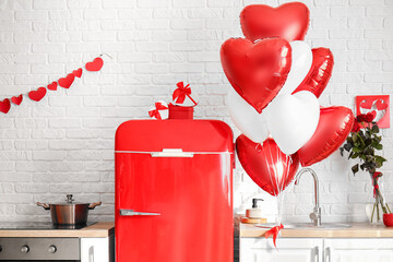 Red fridge, counters with stylish decor and heart shaped air balloons in kitchen decorated for...