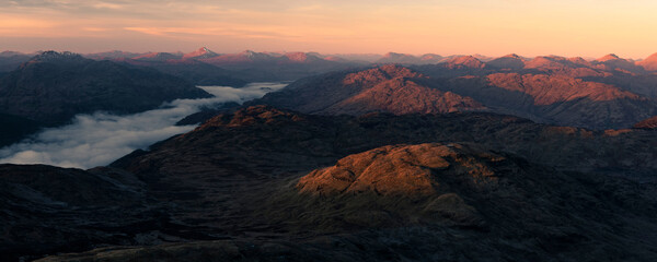 Obraz premium Scottish Highlands mountain landscape at sunset, taken when hiking up Ben Lomond in Trossachs National Park, Scotland, United Kingdom, Europe