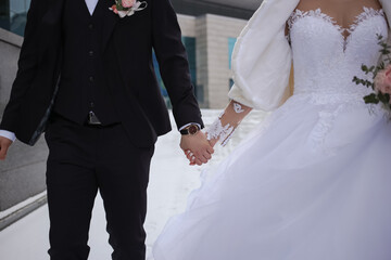 Couple of newlyweds walking hand in hand