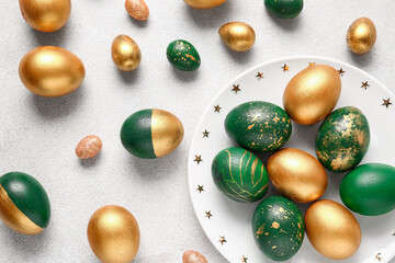 Plate with stylish Easter eggs  on light background