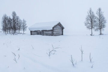 Cabin in a cold winter landscape in Lapland inside the Arctic Circle in Finland