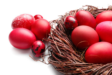 Nest with beautiful Easter eggs isolated on white background, closeup