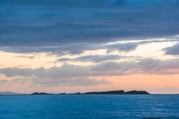 Dramatic orange sunset on the beautiful coastline of the Antrim Coast in Northern Ireland, background with copy space